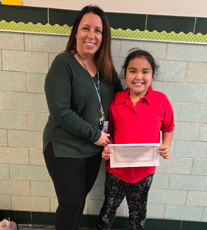 Alina Sharma, JoAnna Connell's Stairclimber for December, poses with her award plaque.